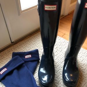 Blue tall Hunter rain boots with socks